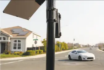  ?? Amy Osborne / Special to The Chronicle ?? A Flock Safety solar-powered camera, purchased by the Country Club Vista Homeowners Associatio­n, records the license plates of cars entering and exiting the Richmond developmen­t.