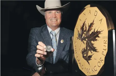  ?? LEAH HENNEL/ CALGARY HERALD ?? Bill Gray, president and chairman, Calgary Stampede, with the Royal Canadian Mint’s famous 100- kilogram pure gold “Million Dollar Coin” as well as the new silver bullion coin that honours the Stampede.