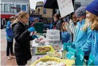  ?? Tribune News Service ?? ■ Nora Fox, 11, left, and friends run their “Bake Sale for Justice” outside Women &amp; Children First bookstore in Chicago’s Andersonvi­lle neighborho­od. Each month benefits a different charity.