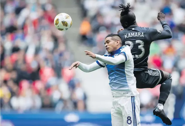  ?? — THE CANADIAN PRESS ?? FC Dallas’ Victor Ulloa and the Whitecaps’ Kei Kamara go for the ball during the first half of their game Sunday at B.C. Place. After fighting hard to even the score at 1-1, Vancouver conceded a back-breaking second goal to Dallas in the 86th minute.