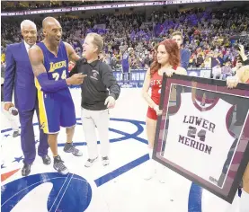  ?? CHARLES FOX/AP ?? Former NBA player Julius Erving, left, and Kobe Bryant’s Lower Merion High School coach Gregg Downer, third from left, present Bryant, second left, a framed jersey before a game against the 76ers.