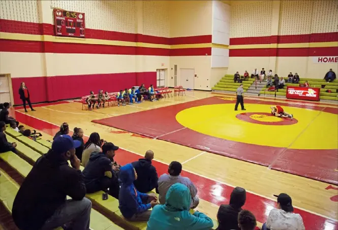  ?? Jessie Wardarski/Post-Gazette photos ?? Spectators watch a wrestling match between Westinghou­se High School and Penn Hills Senior High School in the Penn Hills auxiliary gym on Monday.