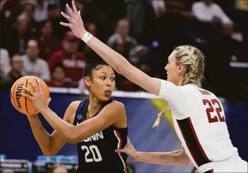  ?? Charlie Neibergall / Associated Press ?? Stanford’s Cameron Brink tries to stop UConn’s Olivia Nelson-Ododa during the first half of the Final Four semifinals of the NCAA Tournament on April 1.