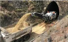  ?? Photo: TMR ?? READY TO ROLL: Workers dredging gravel and sand to lower and widen an old train tunnel along the range to make them large enough to handle modern contain freight.