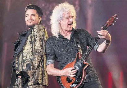  ?? CHARLES SYKES THE ASSOCIATED PRESS FILE PHOTO ?? How did Queen’s Brian May, right, seen with Adam Lambert, hurt himself with “over-enthusiast­ic gardening,” Vinay Menon wonders.