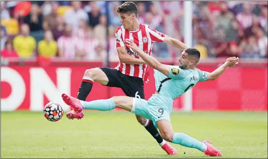  ??  ?? Brentford’s Christian Norgaard (left), and Brighton and Hove Albion’s Neal Maupay battle for the ball during their English Premier League soccer match at The Brentford Community Stadium, London, Saturday, Sept 11, 2021. (AP)