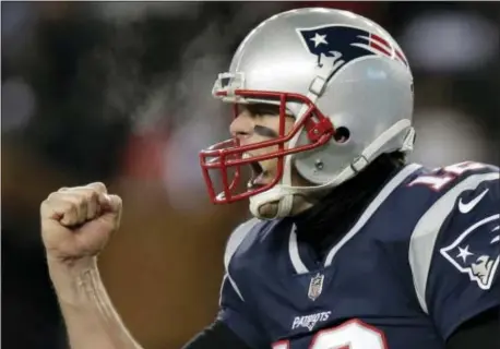  ?? CHARLES KRUPA — THE ASSOCIATED PRESS ?? Patriots quarterbac­k Tom Brady celebrates a touchdown by Brandon Bolden during the second half of a divisional playoff football game against the Titans Saturday.