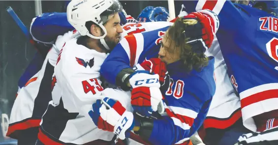  ?? BRUCE BENNETT/USA TODAY ?? Capitals tough guy Tom Wilson works over Rangers star Artemi Panarin on Monday night at Madison Square Garden. The NHL fined Wilson US$5,000 for roughing.