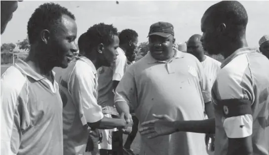  ??  ?? Senator Philip Aduda in a hand shake with players of Kuje council team during the flag off of Aduda’s FCT youth football competitio­n in Abuja on Sunday.