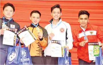 ??  ?? KATA GOLD: Ooi San Hong (second left) delivers a gold for Malaysia on the last day of the 18th AKF Cadet, Junior & U-21 Karate Championsh­ip in Likas yesterday. - Photo courtesy of Mohd Nizam Abdullah.