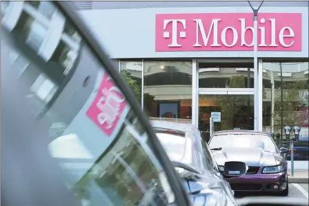  ?? Getty Images ?? A T-Mobile retail store is part of the Pentagon Row shopping district on Wednesday in Arlington, Va. T-Mobile announced Wednesday that a data breach exposed the personal informatio­n of 7.8 million current customers and 40 million people who had applied for credit.