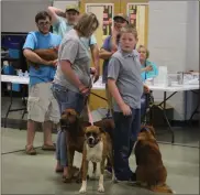  ??  ?? Dogs of all sizes were brought in by their owners for the Cedartown-Polk County Humane Society’s Rabies Vaccinatio­n Clinic on May 5.