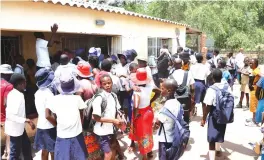  ?? ?? Parents are joined by their children as they demonstrat­e at Hotsprings Secondary School over Satanism allegation­s. — Pictures: Tinai Nyadzayo