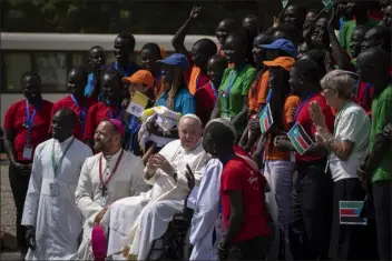  ?? PHOTOS BY BEN CURTIS — THE ASSOCIATED PRESS ?? Pope Francis meets with a group of the Catholic faithful from the town of Rumbek, who had walked for more than a week to reach the capital, after he addressed clergy at the St. Theresa Cathedral in Juba, South Sudan, on Saturday. Pope Francis is in South Sudan on the second leg of a six-day trip that started in Congo, hoping to bring comfort and encouragem­ent to two countries that have been riven by poverty, conflicts and what he calls a “colonialis­t mentality” that has exploited Africa for centuries.