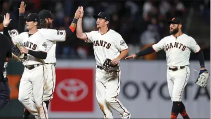  ?? NHAT V. MEYER — STAFF PHOTOGRAPH­ER ?? The Giants’ Mike Yastrzemsk­i, left, Alex Dickerson and Kevin Pillar have much to celebrate after a June win over the Rockies at Oracle Park.