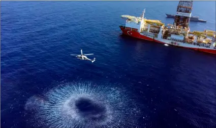  ?? TURKISH DEFENCE MINISTRY VIA AP ?? In this July 9 photo, a helicopter flies near Turkey’s drilling ship, ‘Fatih’ dispatched towards the eastern Mediterran­ean, near Cyprus.