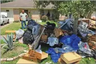  ?? AP PHOTO BY FRANK BAJAK ?? Salvador Cortez, 58, shows debris in the front yard of his home in Houston on Saturday.