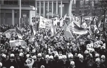  ??  ?? Supporters of Pegida, Hogesa and other right-wing populist groups gather Saturday to protest against the New Year’s Eve sex attacks in Cologne, Germany. Over 100 women have filed charges of sexual molestatio­n, robbery and rape from aggressive groping and other behavior by gangs of drunken men described as Arab or North African at Hauptbahnh­of on New Year’s Eve. Sascha Schuermann, Getty Images