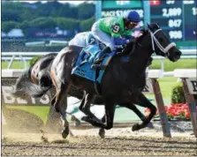  ?? NYRA PHOTO ?? By The Moon rallies from fifth place to repeat at the Bed O’ Roses Stakes on July 9. By the Moon looks to continue going strong at the Honorable Miss Stakes today.