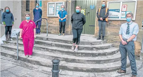  ??  ?? STEPPING UP: Doctors Sara Mcquitty, Callum Duncan, Kirsty Mcquitty, Steve Mcfarlane, Hannah Dakin and former Bell Baxter pupils, Sean Colgan, in the high vis vest, and Tara Gibson, front centre, at the Cupar Corn Exchange.