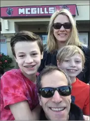  ?? SUBMITTED PHOTO ?? Bones Brigade alum Jami Godfrey with wife Jessica Jones and their sons, Mason and Carter — collective­ly dubbed the Jones Brigade — during a visit to Bones Brigade vet Mike McGill’s California skateboard shop.