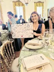  ?? Provided ?? Briana Morales, the 2023 Illinois Teacher of the Year from East St. Louis School District 189, holds a letter signed by her students and fellow staff at Gordon Bush Alternativ­e Center while attending the first-ever state dinner for educators at the White House on May 2, 2024.