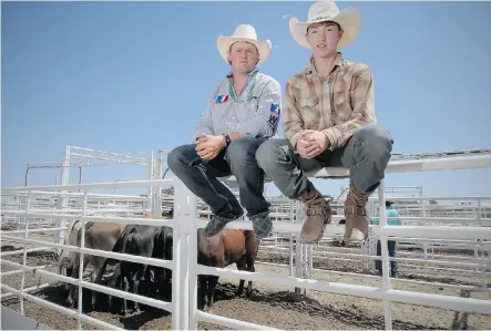  ?? Stuart Gradon/Calgary Herald ?? Steer rider Arlan Lumgair, 13, right, had help from Canadian rodeo star Tanner Girletz at the Calgary Stampede on Wednesday.