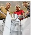  ?? STAFF / FILE ?? University of Dayton Research Institute scientists and engineers Chadwick Barklay (left), Daniel Kramer and Richard Harris test a special generator that can handle weather extremes, to put it mildly.