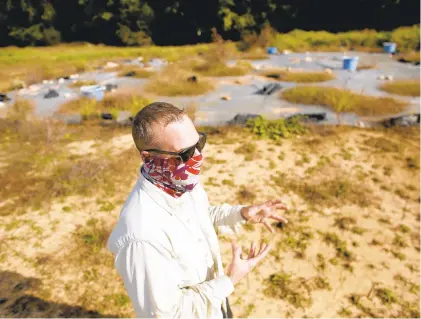  ?? STEPHEN M. KATZ/STAFF ?? City of Newport News archaeolog­ist Aaron Lamb talks about a dig site believed to be Young’s Tavern in Warwick Towne, located on the grounds of the former City Farm on Thursday.