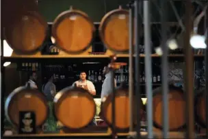  ?? ?? Barrels of brandy are shown at a bar in Belgrade.