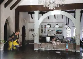  ?? Associated Press photo ?? Bill Asher walks through mud in his home damaged by storms in Montecito, Calif.