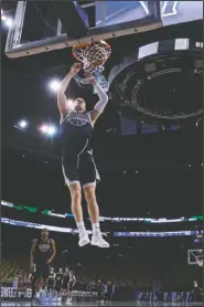  ?? The Associated Press ?? SWEET 16: Villanova’s Donte DiVincenzo (10) dunks during practice at the Hoyas’ practice Thursday in Boston. Villanova faces West Virginia in a regional semifinal tonight.