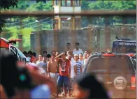  ?? CLAUDIO REIS/O POPULAR VIA ASSOCIATED PRESS ?? Prisoners try to contact relatives after a riot at the Colonia Agroindust­rial prison in Goias, Brazil, on Monday.