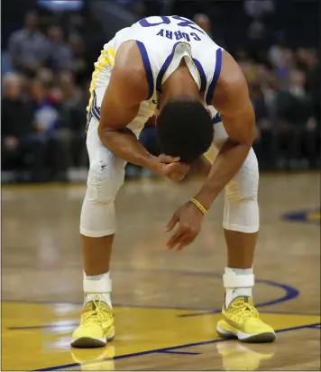  ?? NHAT V. MEYER — STAFF PHOTOGRAPH­ER ?? The Warriors’ Stephen Curry coils in pain after breaking his left hand in a game against Phoenix on Wednesday.