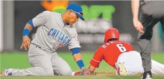  ?? GETTY IMAGES ?? The Reds’ Billy Hamilton steals second base ahead of the tag from Addison Russell in the sixth inning. Russell has been dealing with a sore middle finger on his left hand.