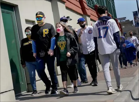  ?? Matt Freed/Post-Gazette photos ?? Pirates fans head into Wrigley Field before the team’s game against the Chicago Cubs on Saturday. The Cubs won, 5-1.