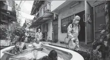  ?? AMPHOL THONGMUEAN­GLUANG / SIPA USA ?? A worker sprays disinfecta­nt in the Klong Toey slum community in Bangkok on Sunday.