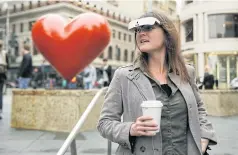  ??  ?? Yvonne Felix wears eSight electronic glasses in Union Square, San Francisco.