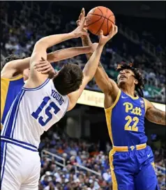  ?? Grant Halverson/Getty Images ?? Nike Sibande, right, contests Duke’s Ryan Young for a rebound Thursday in the Pitt’ss 96-69 loss.