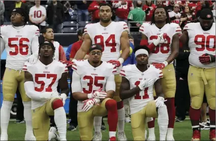  ?? AP PHOTO/DAVID J. PHILLIP ?? In this Dec. 10, 2017, file photo, San Francisco 49ers’ Eli Harold (57), Eric Reid (35) and Marquise Goodwin (11) kneel during the national anthem before an NFL football game against the Houston Texans, in Houston.