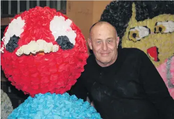  ?? PHOTO: TOM KITCHIN ?? Paper supplies thin . . . Alexandra Blossom Festival event manager Martin McPherson is surrounded by floats for the festival made with crepe paper, which is now hard to obtain in New Zealand.