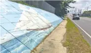  ?? AP PHOTO/KEVIN MCGILL ?? Traffic passes a mural of the slave ship Clotilda along Africatown Blvd. in Mobile, Ala., in May. The discovery of the last ship that brought Africans to the United States as slaves may offer a test case for reparation­s.