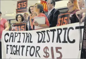  ?? Paul Buckowski / Times Union ?? Jessica Wisneski, center, of Citizen Action of New York, called for a $15 minimum wage for all workers in 2015 at Empire State Plaza.