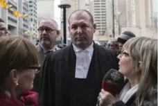  ?? CHRIS YOUNG/THE CANADIAN PRESS ?? Peter Brauti, centre, who represente­d James Forcillo, said his defence team started “behind the 8-ball” because videos of the shooting were featured widely on social media before the trial began.