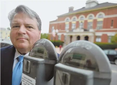  ?? HERALD PHOTO BY JIM MICHAUD ?? BEATEN METERS: Revere At-Large Councilor and former mayor Dan Rizzo stands behind parking meters. The council took a preliminar­y vote yesterday to bring in the feds and state auditor to find missing parking revenue.