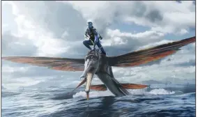  ?? ?? Jake Sully (Sam Worthingto­n) rides a weird fish with wings in “Avatar: The Way of Water,” which remains at No. 1 with $56 million in receipts fro U.S. and Canadian theaters.