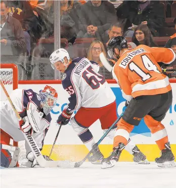  ?? BRUCE BENNETT/GETTY IMAGES ?? Blue Jackets goalie Sergei Bobrovsky covers the puck during the first period as the Flyers’ Sean Couturier looks for the rebound Thursday night at the Wells Fargo Center in Philadelph­ia.