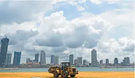  ?? (AFP) ?? A labourer works at the constructi­on site on reclaimed land as part of the Chinese-funded project for Port City in Colombo on November 8