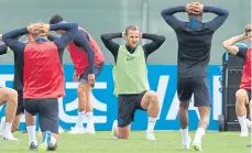  ??  ?? Nice to be here: From top to bottom, England captain Harry Kane and manager Gareth Southgate accept gifts, Kane signs a football for a young fan before the getting to the serious business of a squad training session