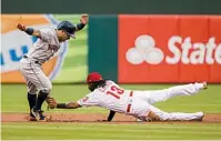  ?? AP Photo/ Chris Szagola ?? n Houston Astros' Jose Altuve, left, tries to get away from a tag by Philadelph­ia Phillies shortstop Freddy Galvis after he overran second base during the first inning Monday in Philadelph­ia. Altuve was out on the play.